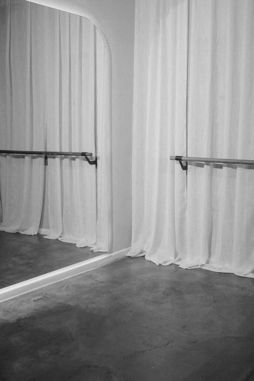 The Sane Studio barre and sheer curtains, in black and white